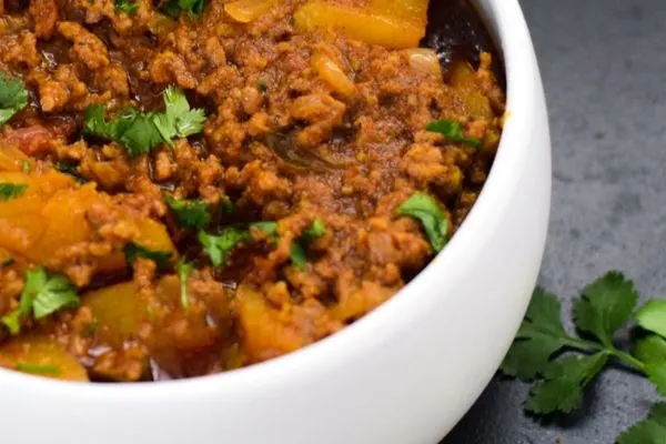 Mince curry with potatoes in a white bowl