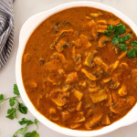 Mushroom curry cooked with tomatoes, yogurt and spices