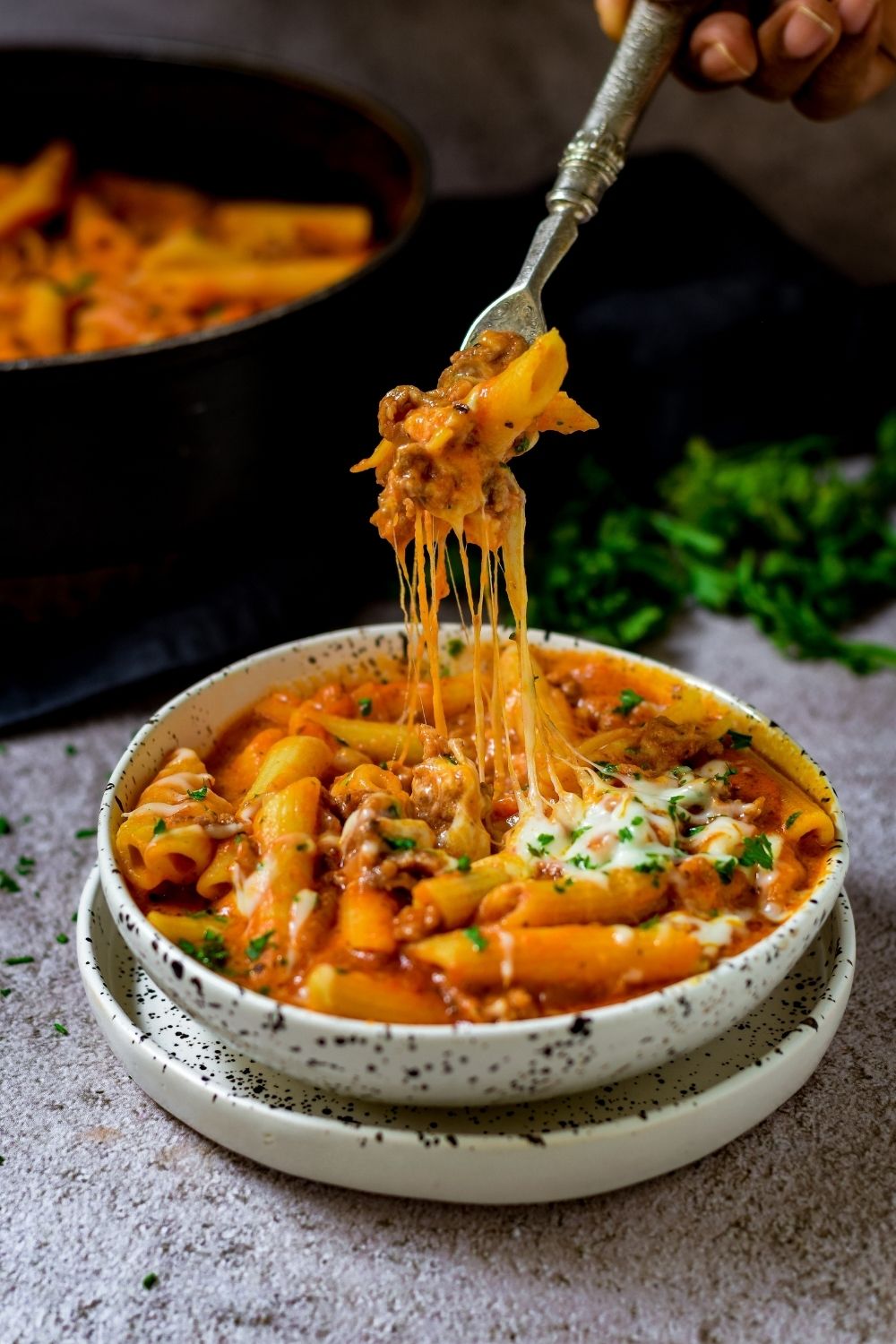 Spicy Tomato Lamb Pasta in a black and white bowl