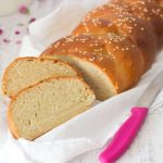 Braided Bread on a white cloth with a pink knife on the side
