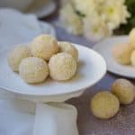 Soji Balls on a white cake stand with flowers at right back