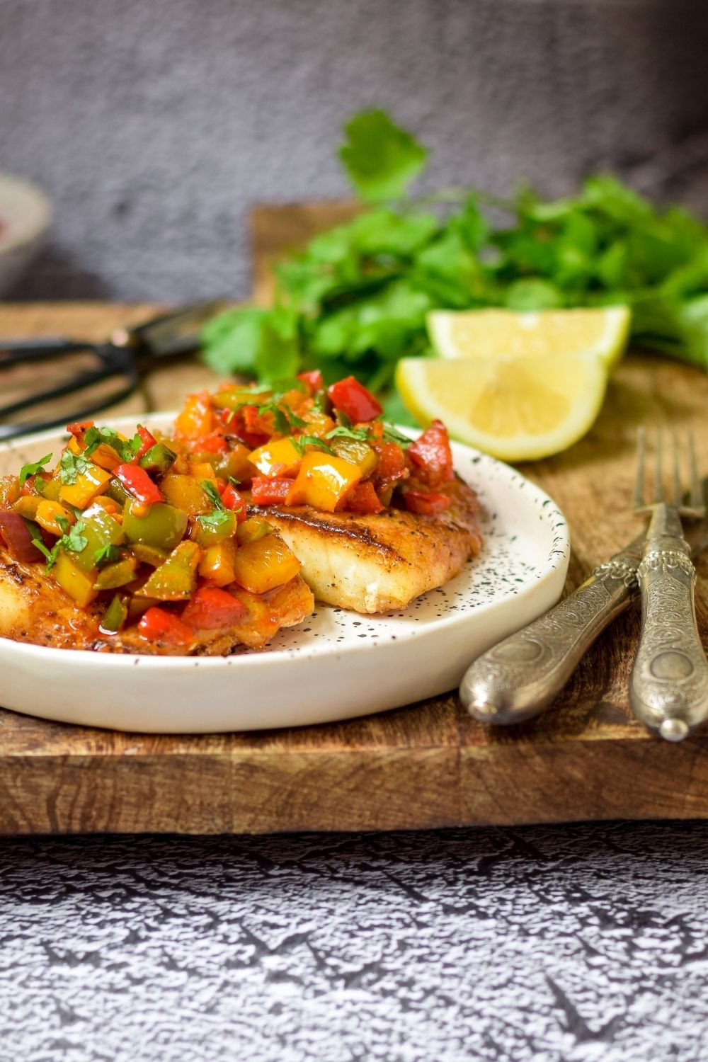 Spicy Pan Fried Fish with peppers in a white plate