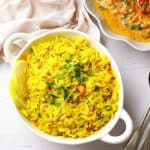 Spicy Rice in a white bowl with a bowl of fish at the top right