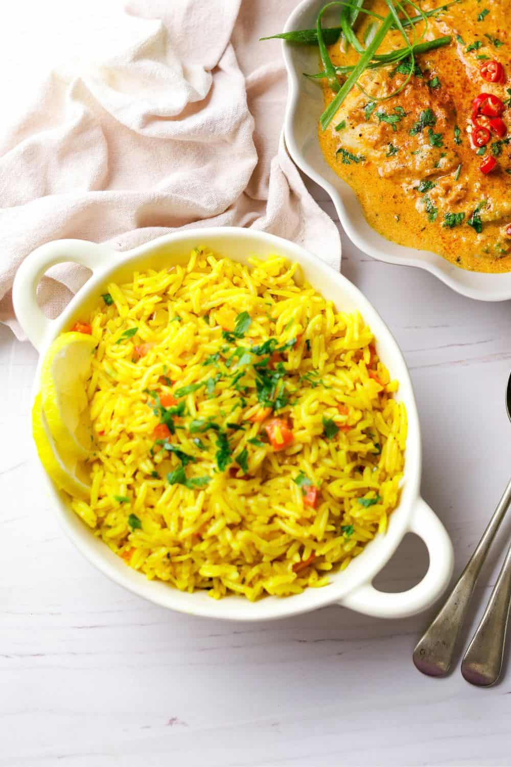 Spicy Rice in a white bowl with a bowl of fish at the top right